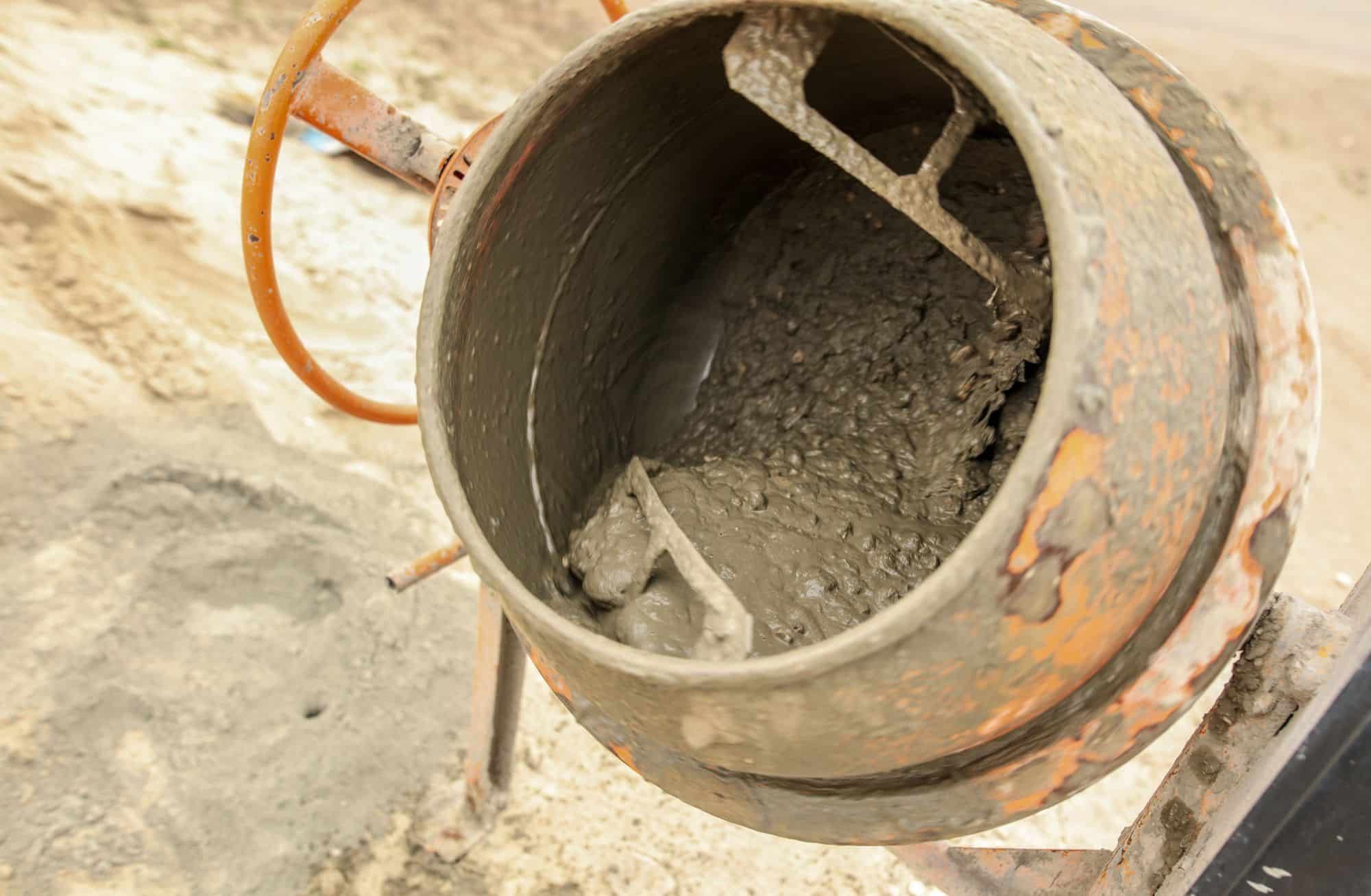 Man pouring concrete mix using a pump