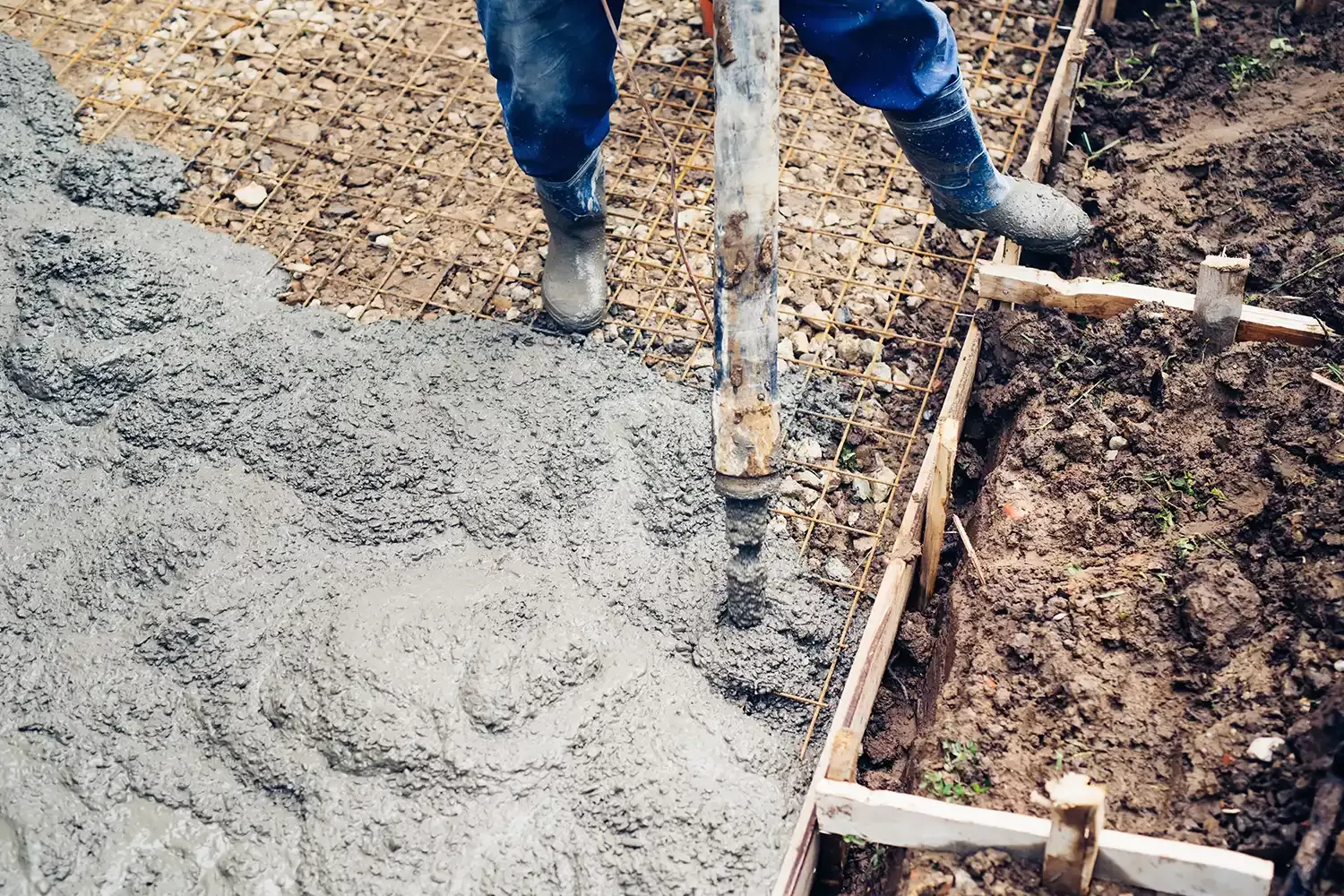 Man pouring concrete mix using a pump