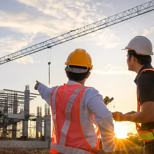 Contractors discussing plans on constructions site