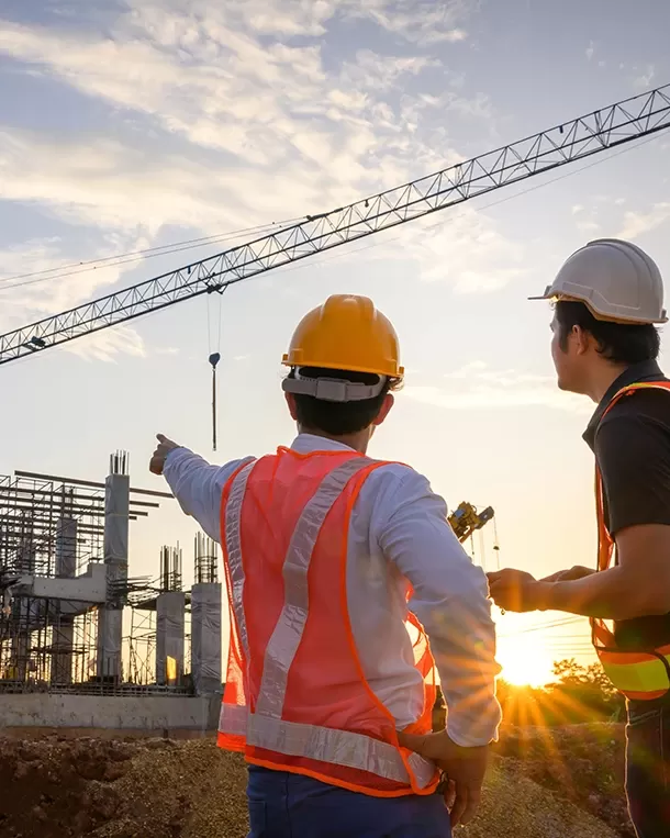 Contractors discussing plans on constructions site