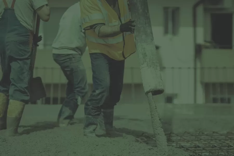 Workers pouring cement from GB Concrete Pump