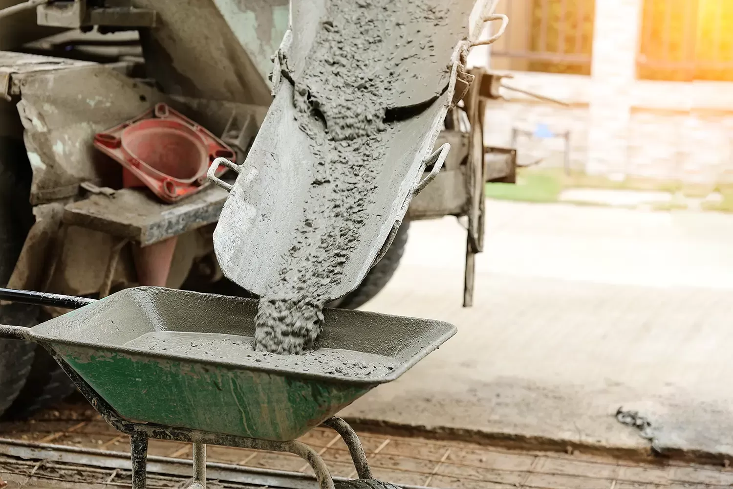 Concrete mix being poured into wheel barrow