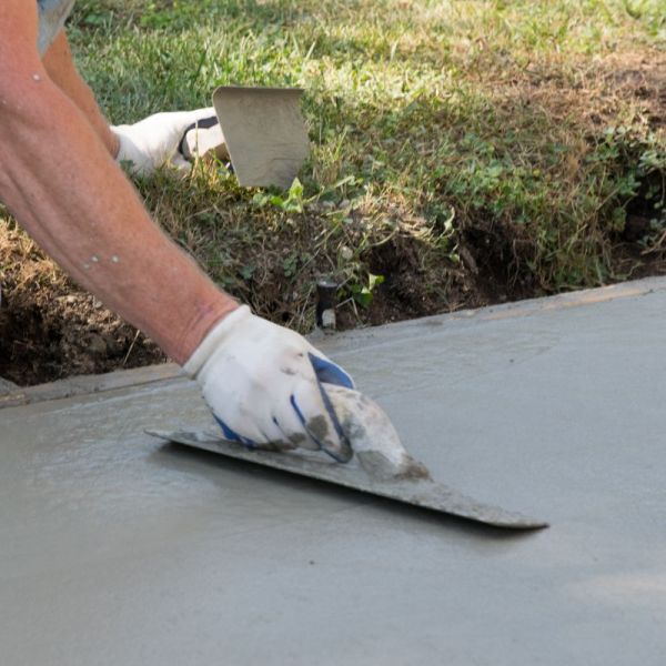 smoothing out concrete on a driveway